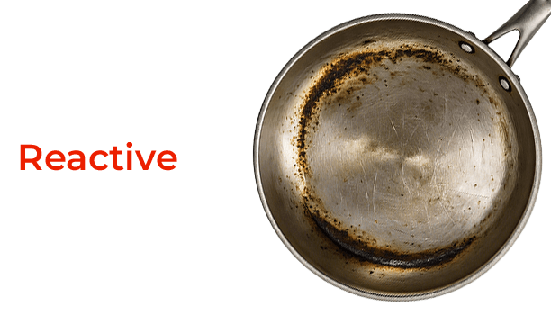 Rust-covered frying pan with 'Reactive' text on a black background